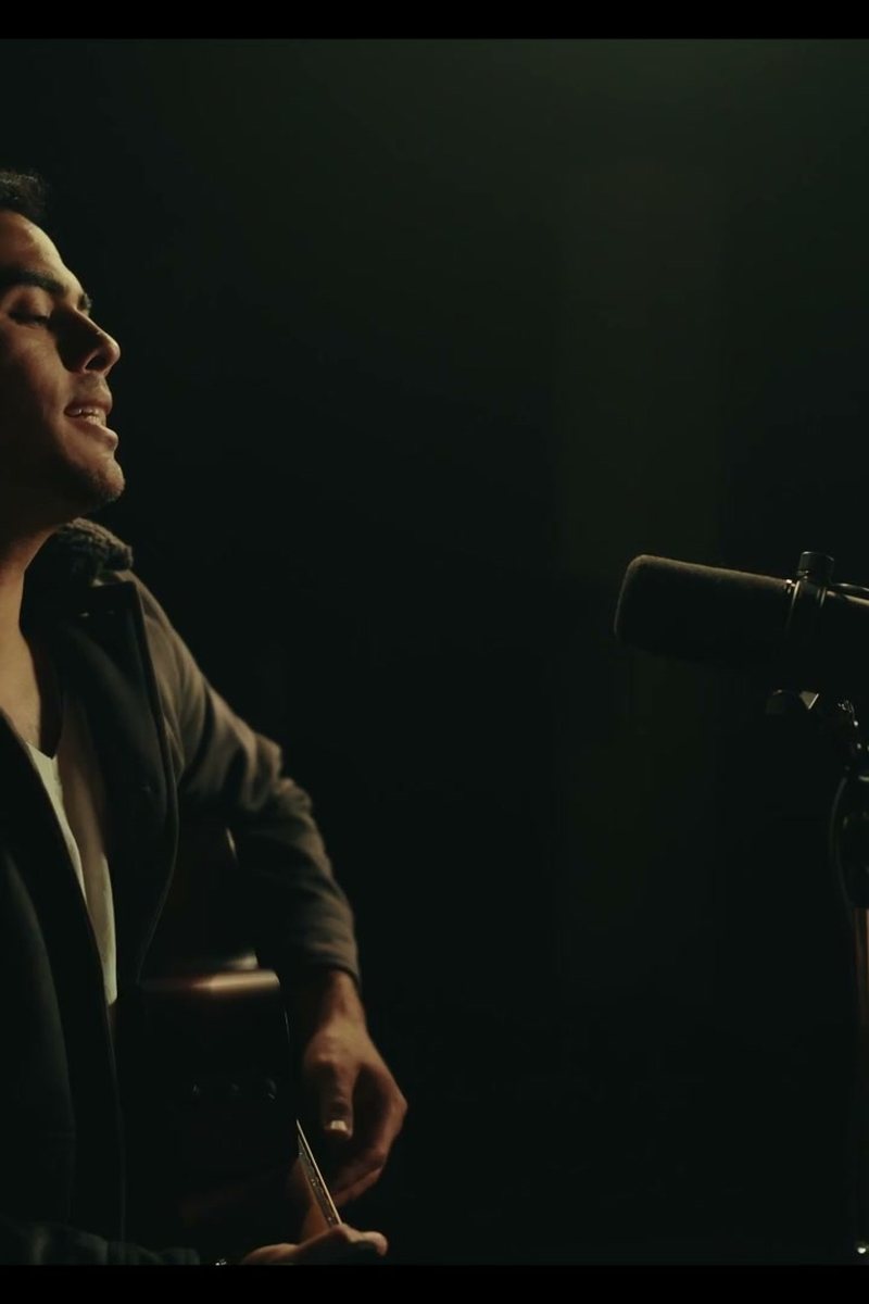 Trevor James singing at a microphone
